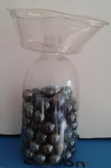 After melting a hole in the bottom of the deli container, I fitted it over a handsoap bottle and weighted it with florist's pebbles and voila - a vase!